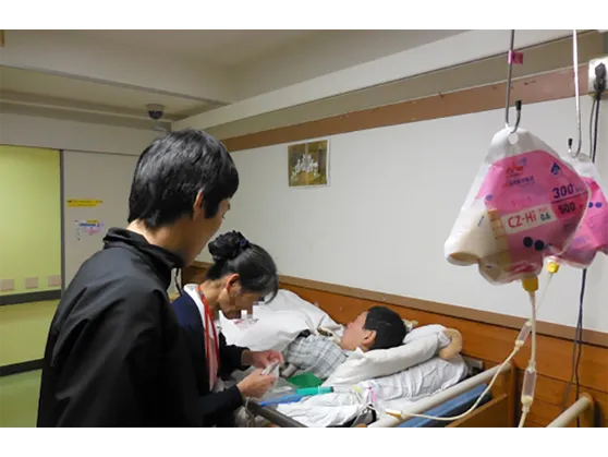 生活棟で医療処置にあたる看護師の写真